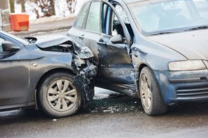 Car crash accident on street with damaged automobiles after collision